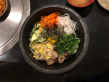 High angle view of chopped vegetables in black hot stone pot