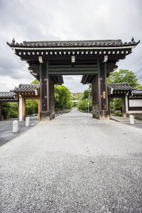 Road leading towards temple against sky