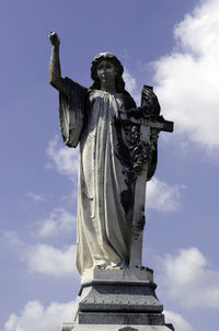 Low angle view of statue against cloudy sky