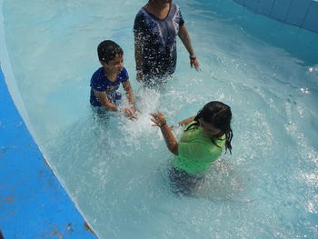 Full length of father and daughter in water