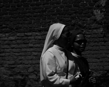 Woman standing against wall