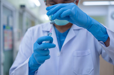 Midsection of person holding umbrella