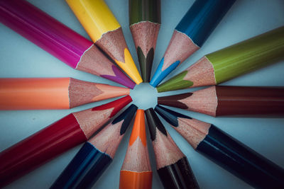 Close-up of colored pencils arranged on table