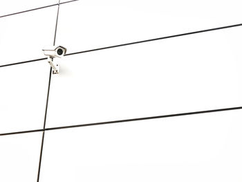 Low angle view of electricity pylon against clear sky