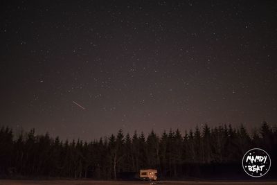 Scenic view of trees against sky at night