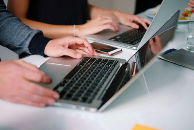 Surface level view of two people using laptops
