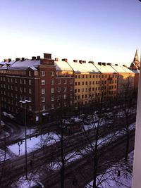 Buildings in city against cloudy sky