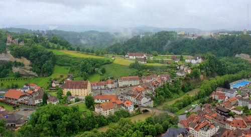 High angle view of houses and trees against sky