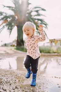 Portrait of cute girl standing on beach