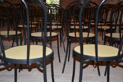 Empty chairs and tables in row