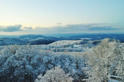 Scenic view of snow covered mountains against sky