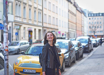 Young woman standing on city street