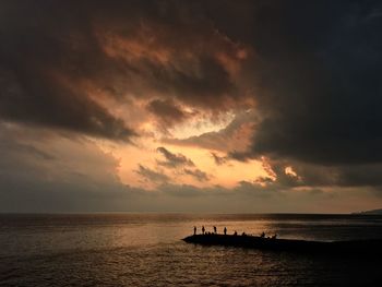 Silhouette boat in sea against sky during sunset