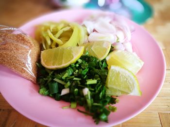 High angle view of chopped vegetables in plate on table