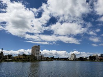 Buildings in city against cloudy sky