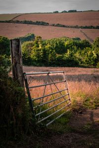 Fence on field against sky