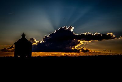 Silhouette of trees against sky at sunset