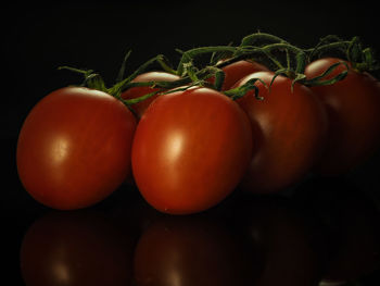 Close-up of cherry tomatoes against black background