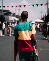 Rear view of man standing on road