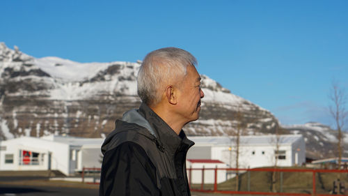 Side view of man against mountain against sky