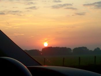 Scenic view of sunset seen through car windshield