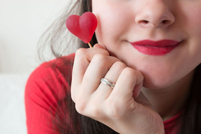 Close-up of woman with red hands