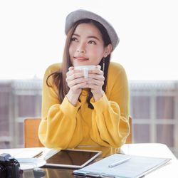 Portrait of mature man holding coffee cup on table