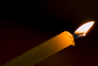 Close-up of illuminated lamp against black background