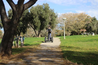 Boy riding bicycle on country road