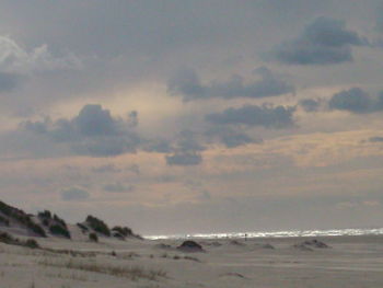Scenic view of beach at sunset
