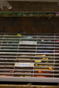 High angle view of multi colored pencils on metal