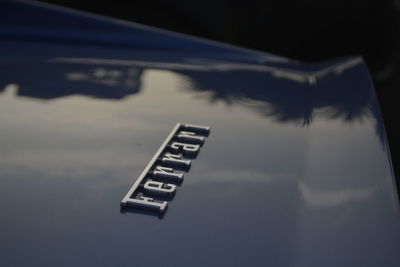 Close-up of information sign against sky