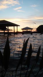 Pier on sea at sunset