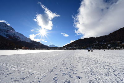 Scenic view of snow covered field against sky