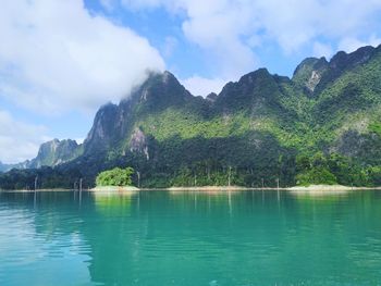 Scenic view of lake and mountains against sky