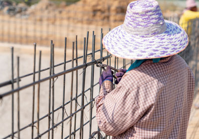 Worker bundle wire steel rod in construction site.