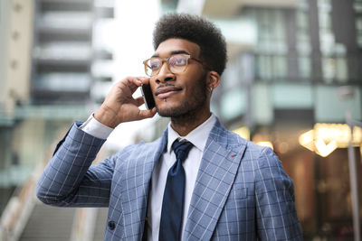 Portrait of young man holding camera