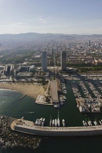 Spain, catalonia, barcelona, helicopter view of city beach and marina