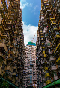 Low angle view of buildings in city against sky