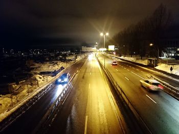 Light trails on road in city at night