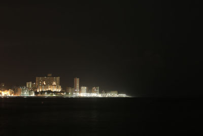 Illuminated buildings in city at night