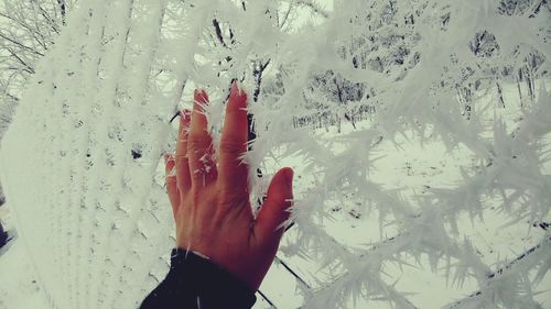 Reflection of hand on wet glass