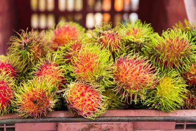Close-up of rambutans for sale at market stall