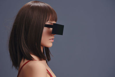 High angle view of woman looking away against clear sky
