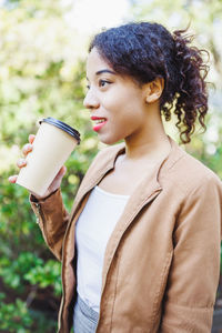 Young woman drinking coffee in cafe
