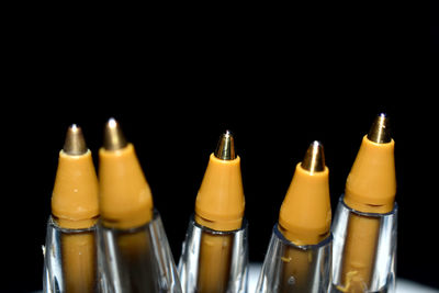 Close-up of glasses on table against black background