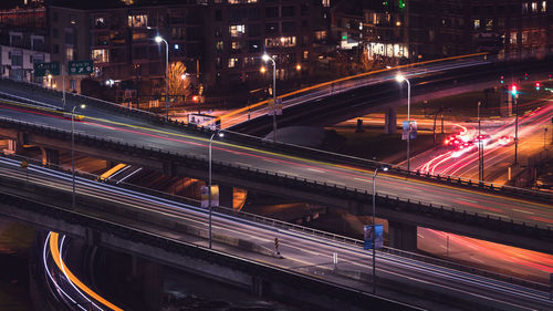 High angle view of light trails on bridge in city at night