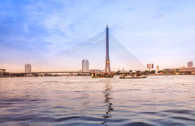 View of suspension bridge with city in background