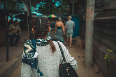 Rear view of friends standing outdoors