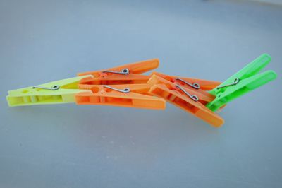 Close-up of multi colored clothespins on white background